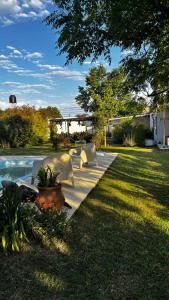 a group of white chairs sitting next to a pool at ESPACIO CANELA in Ramallo