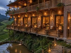 a house on a bridge over a river at OH Pu Luong Homestay in Làng Bang