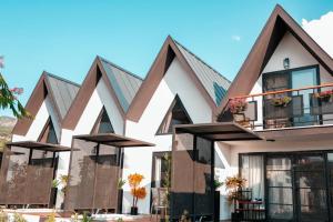 a large white building with black roof at Ladik Hotel in Karahayit
