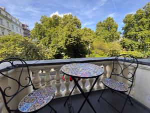 a table and two chairs sitting on a balcony at Jubilee Hotel Victoria in London