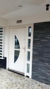 a white garage door with a clock on it at Casa de alejo in Pereira