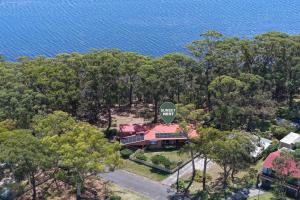 an overhead view of a house with trees and the water at Sunset Nest No 1 in Sanctuary Point