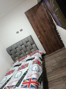 a bedroom with a bed with a quilt on it at Casa de alejo in Pereira