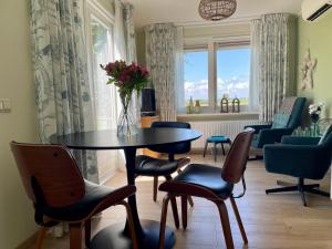 a table and chairs with a vase of flowers on it at Welcome by Bianca in Jisp