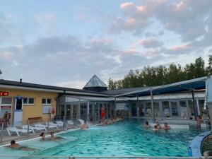 a group of people sitting in a swimming pool at Alexandra Nesvady in Nesvady