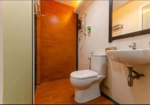a bathroom with a toilet and a sink at Hotel Dream Nur Kota Syahbandar in Malacca