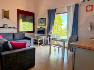 a living room with a couch and a table at Yasoo Holiday Apartments in Olympiada