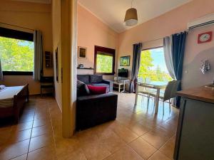 a living room with a couch and a table at Yasoo Holiday Apartments in Olympiada