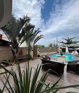 a patio with chairs and a swimming pool at Pousada da Mel in Florianópolis