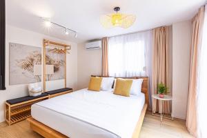 a bedroom with a large white bed and a window at Dhermi's Icon Big 1BR Ap 15 in Dhërmi