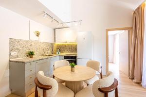 a kitchen with a table and chairs in a kitchen at Dhermi's Icon Big 1BR Ap 15 in Dhërmi