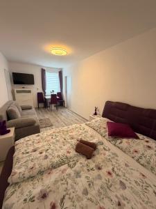 a bedroom with a large bed with a flowery blanket at Apartmány KK in Chvalovice