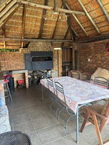 a table and chairs in a room with a fireplace at Tsheryl's Residence in Centurion