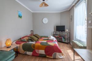 a bedroom with two beds and a tv in it at Brise Lavalloise - Wifi - Centre Ville in Laval +11 photos