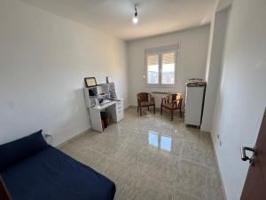 a living room with a bed and a desk with a computer at Equipped apartment with elevator, sea view in Bordj el Bahri