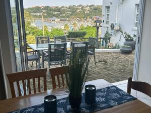 a dining room table with a view of a patio at Dockside in Port Alfred