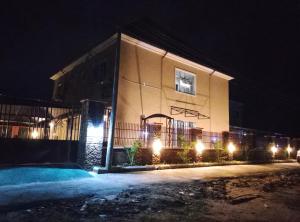 a building with lights in front of it at night at Vinoregis Entertainment Lounge in Owerri