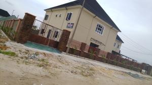 a house on the side of a dirt road at Vinoregis Entertainment Lounge in Owerri