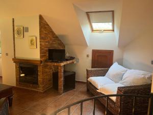 a living room with a couch and a fireplace at Apartamentos La Guergola in Pola de Somiedo