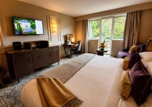a hotel room with a large bed and a flat screen tv at Maryborough Hotel & Spa in Cork