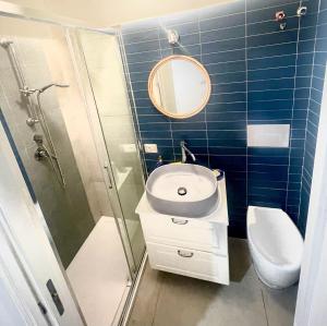 a bathroom with a sink and a shower and a toilet at Casa Peloro in Torre Faro +11 photos