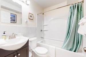 a bathroom with a sink and a toilet and a tub at Gunstock Getaway in Gilford +18 photos