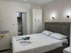 a bedroom with a large bed with flowers on it at Fortunella Apartments in Herceg-Novi
