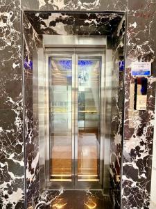 a metal elevator in a room with a wall at LuXus Resort & Swimming Pool in Pondicherry