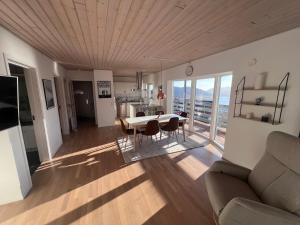 a kitchen and living room with a table and chairs at Arctic Hostel Apartment in Qaqortoq