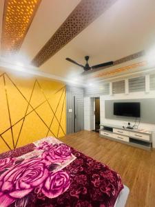 a bedroom with a bed and a television in it at Hotel rexa in Vrindāvan