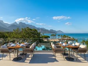 a restaurant with a view of the ocean and mountains at Nirvana Mediterranean Excellence - Ultra All Inclusive in Beldibi