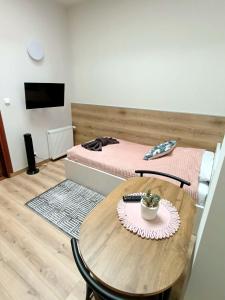 a room with a table and a bed with a bed at Hotelik Kościerzyna in Kościerzyna