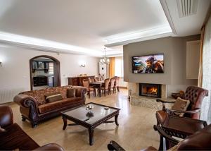 a living room with a couch and a fireplace at Villa Tiara by HolidayKeys in Kyrenia