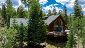 a log cabin in the woods with trees at 94 Ponderosa Way in Durango