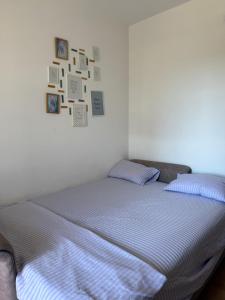 a bed in a bedroom with pictures on the wall at Power view in Bečići