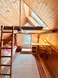 an attic room with a bunk bed and a desk at Zimmer in rustikalem alten Haus in Tiefenpölz