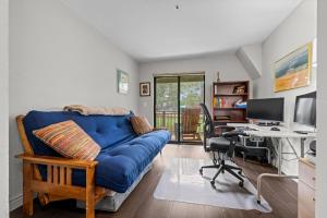 a living room with a blue couch and a desk at Flatirons Hideaway in Boulder CO in Boulder +25 photos