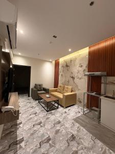 a living room with a couch and a table at بريفير للشقق المخدومة - Privere Serviced Apartments in Riyadh +31 photos