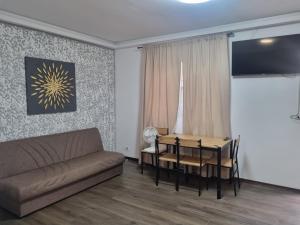 a living room with a couch and a table at Casa Florentina in Făgăraş