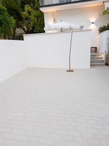 a white tile floor in front of a white wall at Ιόνια Γαλήνη Pool Spa Suite in Parga