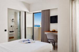 a hotel room with a bed and a desk at DOM Boutique Hotel in Heraklio