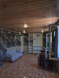 a room with a bed and a stone wall at Guest House in Ureki in Ureki