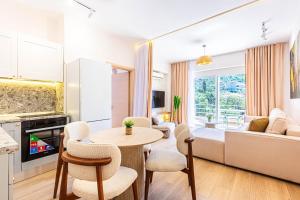 a kitchen and living room with a table and chairs at Dhermi's Icon Big 1BR Apt 6 in Dhërmi