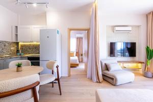 a kitchen and a living room with a table at Dhermi's Icon Big 1BR Apt 6 in Dhërmi