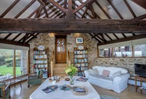 a living room with a couch and a table at Mowhay Barn in Torpoint