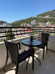 a table and chairs on a balcony with a view at Power view in Bečići