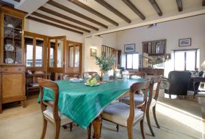 a dining room with a green table and chairs at Mowhay Barn in Torpoint