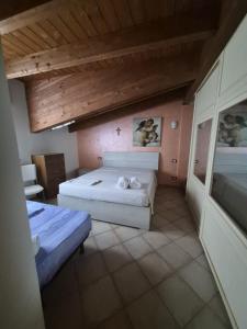 a bedroom with two beds and a wooden ceiling at VILLA ANNAMARIA in Montesilvano