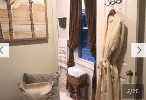 a robe hanging on a door next to a window at Naomi BED and BREAKFAST in Parkville