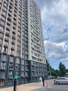 a tall building with a car parked in front of it at ЖК Модерн in Odesa